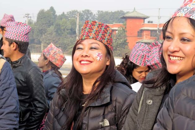 A woman smiles wearing a DhakaTopi (traditional Nepali cap) in a programme organised by the Jagaruk Youth Campaign Nepal to mark the National Costume Day in Maitighar Mandala, Kathmandu, on January 1, 2016. Courtesy: Kamal Phuyal